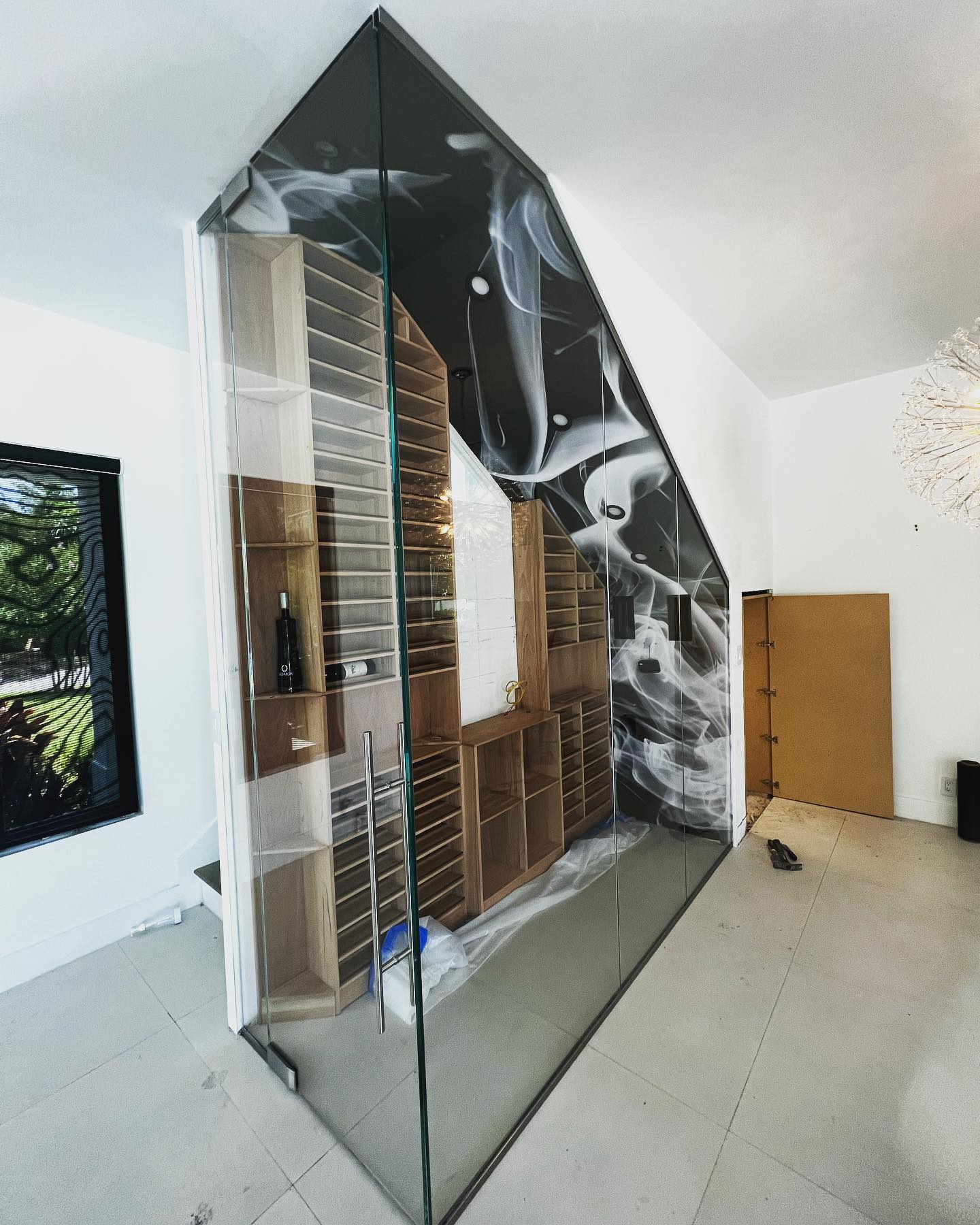 Custom illuminated glass wine room installation