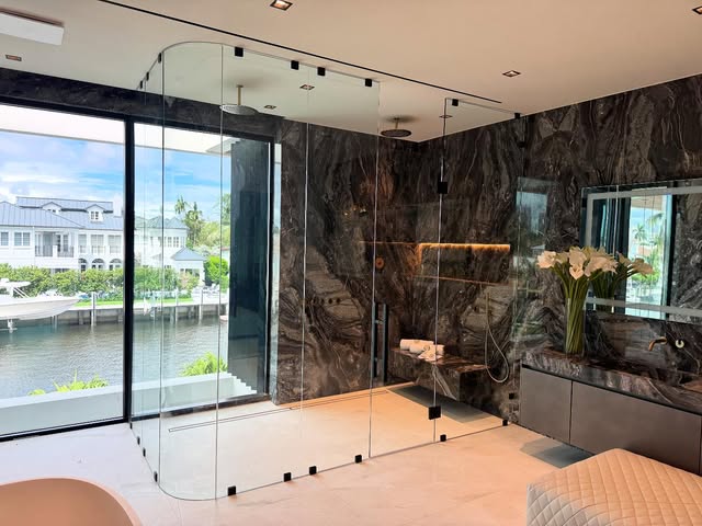 Custom curved glass shower enclosure in a South Florida residence